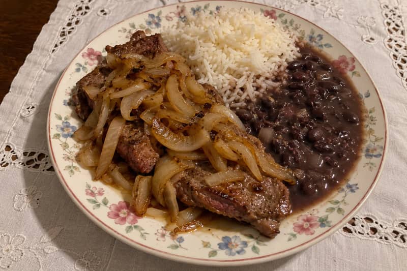 Steak and onions with rice and beans