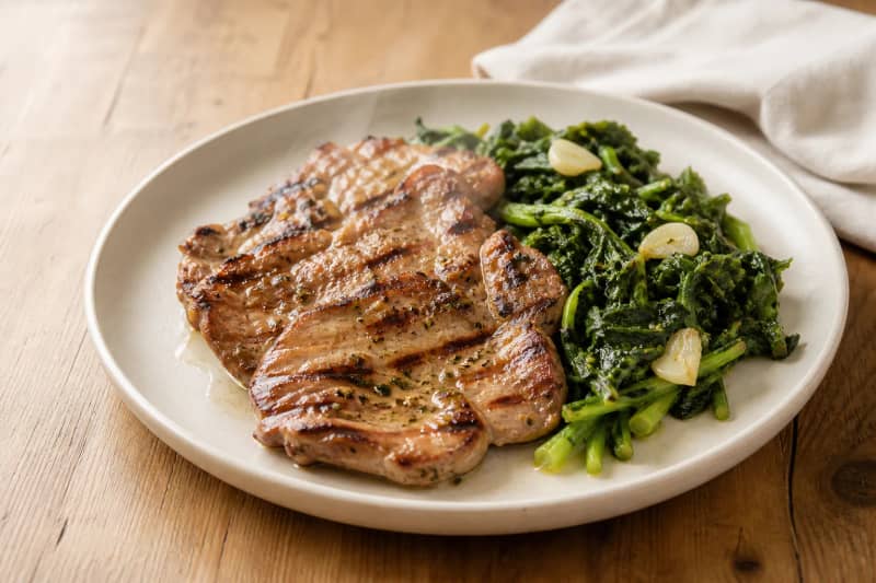 Grilled pork steaks with grelos (turnip greens)