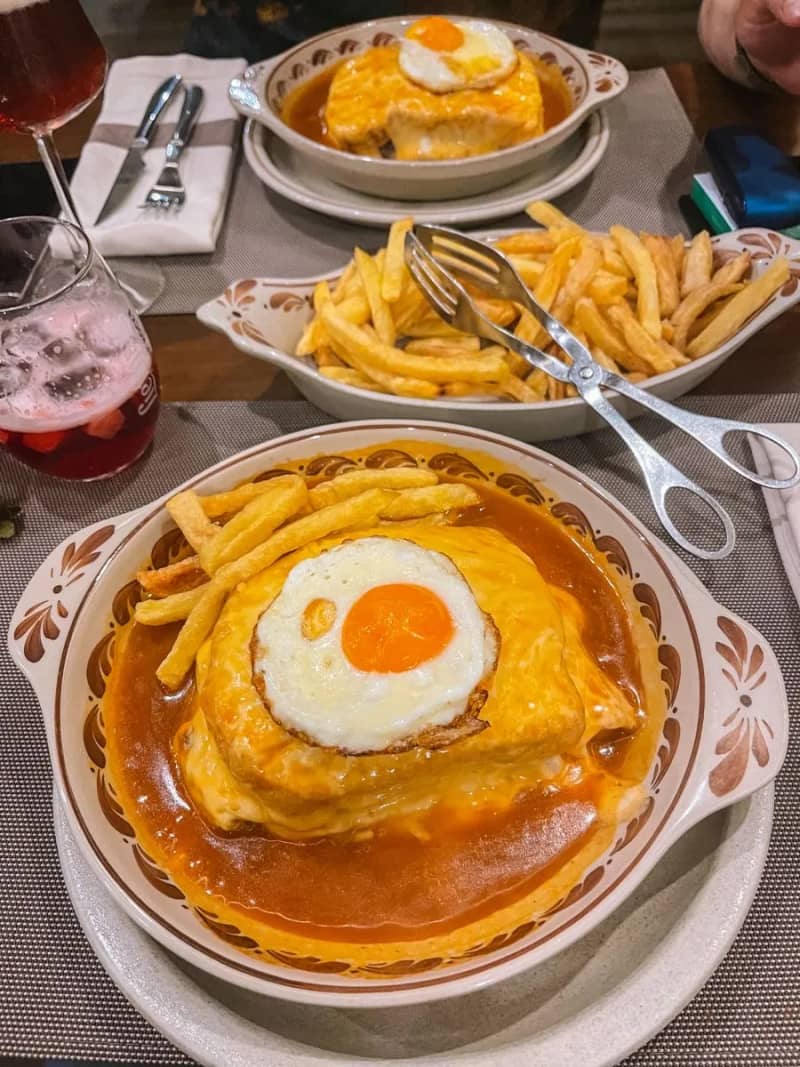Francesinha (Porto-style sandwich with meat and rich spicy sauce)